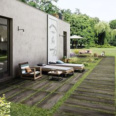 an outdoor patio with lounge chairs and tables