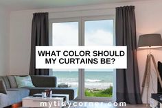 a living room filled with furniture and a large window that says what color should my curtains be?