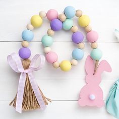 two wooden beads and some bunny decorations on a white table