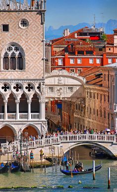 an ornate building on the side of a river with gondolas and boats in front