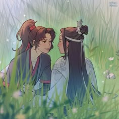 two young women sitting in the grass with their backs to each other and looking at each other