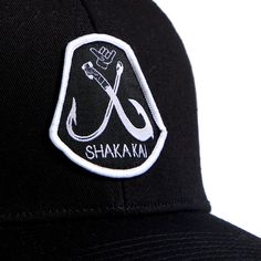 Whether you're hitting the beach or exploring the city, this hat is more than an accessory—it's a statement of your passion for the ocean. Embrace the Shakakai lifestyle and top off your look with the Hooked 6 Panel Trucker Hat, an emblem of your adventurous spirit and love for the endless horizons of the sea. Black Curved Bill Trucker Hat For Beach, Black Trucker Hat With Curved Bill For Beach, Black Curved Brim Fitted Hat For Summer, Black Fitted Hat With Curved Brim For Summer, Black Snapback Fitted Hat For Summer, Black Curved Bill Hat For Summer, Black Snapback Trucker Hat For Beach, Black Snapback Hat For Summer Beach, Black Baseball Cap For Beach