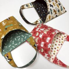 three different types of dog bandannas on a white surface with one being folded up and the other is closed