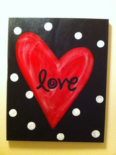 a red heart with the word love painted on it in black and white polka dots