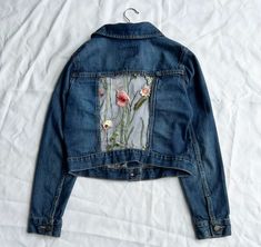 Hand-sewn upcycled jean jacket with floral mesh back. Old Navy size Women's Small. Machine washable, trim loose threads as needed. All profits go to sponsoring a child and her community through Save The Children. For more sizes and styles, contact me or visit my shop at https://www.etsy.com/shop/GiftsForGirlsStudio?ref=l2-about-shopname Spring Recycled Denim Fitted Jacket, Spring Fitted Recycled Denim Jacket, Spring Recycled Denim Patchwork Outerwear, Spring Patchwork Recycled Denim Outerwear, Spring Patchwork Outerwear In Recycled Denim, Fitted Denim Jacket With Patches For Spring, Spring Upcycled Recycled Denim Jacket, Upcycled Long Sleeve Denim Jacket For Spring, Spring Upcycled Long Sleeve Denim Jacket