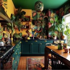 a kitchen filled with lots of potted plants next to a stove top oven under a window