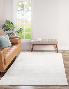 a living room with a couch, coffee table and window