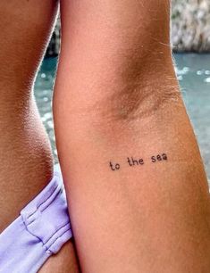 two women with tattoos that say to the sea