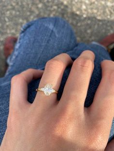 a woman's hand with a diamond ring on it