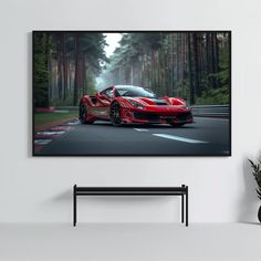 a red sports car driving down the road in front of some trees on a sunny day