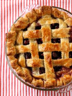 a close up of a pie on a table with a red and white checkered cloth