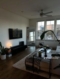 a living room with large windows and wooden floors