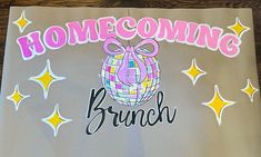 a sign that says,'home coming brunch'with a disco ball on it