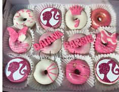 pink and white cupcakes decorated with baby's first birthday decorations in a box