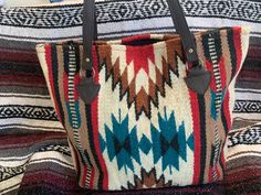 Western Shoulder Bag HandmadeGreat QualityThese bags zip closed at the top and have two pockets on the inside.Dimensions:Width: 18 inchesTall     : 16 inches Shoulder Bag School, Blanket Purse, Aztec Blanket, Sundance Kid, Western Purses, Saddle Blanket, Bag School, Rug Bag, Southwest Style