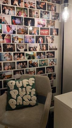 a chair with a pillow sitting in front of a wall full of pictures on it