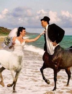 a bride and groom are running on the beach with their horses as they run towards the water