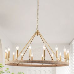 a chandelier hanging from the ceiling in a room with white walls and windows