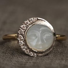 Man in the Moon Ring | Erica Weiner Vintage Oval Engagement Rings, Waning Crescent, Filigree Ring Gold, Man In The Moon, Moissanite Engagement Ring Halo, Twinkling Stars, In The Moon, Moonstone Engagement, Buying An Engagement Ring