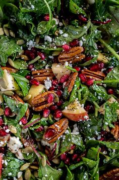 a salad with spinach, apples, nuts and feta cheese on the side