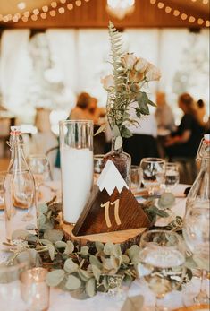 the table is set with candles, flowers and other items for an elegant wedding reception