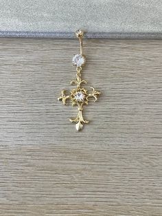 a gold cross with two diamonds on it