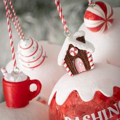 christmas ornaments with candy and candies hanging from strings on top of each ornament