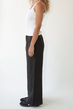 Our favorite everyday pant. Medium weight linen trouser featuring an elasticized waist band and hip pockets. Ankle length with a wide hem. Inseam is ~30". Details: - Barrel shape wide leg. - Tailored mock fly. - Garment washed to increase softness and remove shrinkage. 100% Linen sourced in California Louise is 5'8" and wears size Small. Fitted Black Linen Bottoms, Elegant Wide Leg Bottoms For Everyday, Black Linen Wide Leg Bottoms, Classic Linen Pants With Elastic Waistband, Classic Linen Bottoms With Elastic Waistband, Classic Full-length Linen Wide Leg Pants, Modern Linen Wide Leg Pants For Workwear, Classic Full Length Linen Wide Leg Pants, Classic Full Length Wide Leg Linen Pants