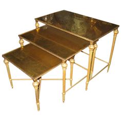 three metal tables with gold trimmings are stacked on top of eachother