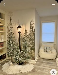 a room decorated for christmas with white trees and snow on the ground in front of a window