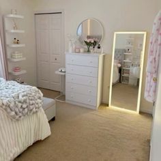 a bedroom with a bed, dresser and mirror