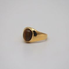 Yellow tiger's eye oval stone takes center stage in this chic gemstone ring. Plated in 18k gold, this ring is a unique addition to your daily jewelry box. 18k gold plated Stainless steel base Waterproof and tarnish free Available in US6-10 Ring sizing chart Tigers Eye Ring Gold, Tigers Eye Rings, Tigers Eye Wedding Ring, Tigers Eye Engagement Ring, Tiger Eye Stone Jewelry, Tigers Eye Jewelry, Tigers Eye Ring, Dazzling Jewelry, Money Candle