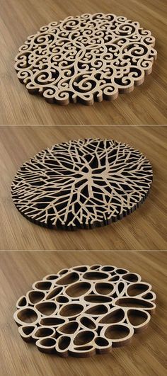 three different types of circular wooden coasters on a wood floor with circles and trees carved into them