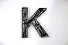 the letter k is made up of chains and screwdrivers on a white background