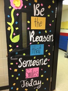 a classroom door decorated with the words be the reason that someone smiles today