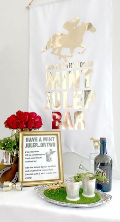 a table topped with plates and cups filled with flowers next to a sign that reads, don't mess i need bar