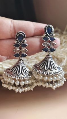 Very Fine Oxidized Silver Plated Jadau Cz Stones with Pearl Blue & Silver Jhumki / Indian Bollywood Style Earrings / Afghani Tribal Earrings Gorgeous Dangle Oxidized silver  earrings - Contemporary earrings with simulated stones in silver finish. - Very Elegant and stylish, these earrings can be paired with any traditional Indian or Western Attire depending upon the occasion and the theme. - The base is pure brass (90%) and pure 92.5 silver (10%) which makes this very sturdy and of good quality. - 100% guarantee on the polish- it will not lose its finish/color/shine. - Very lightweight and Hand carved. Its a very Fine Quality of silver long jhumke  Highest quality and craftsmanship, Ready to ship from India  Please contact us any questions Contemporary Silver Earrings, Oxidized Silver Earrings, Contemporary Earrings, Bollywood Style, Indian Bollywood, Oxidized Silver, Traditional Indian, Style Earrings, Cz Stone