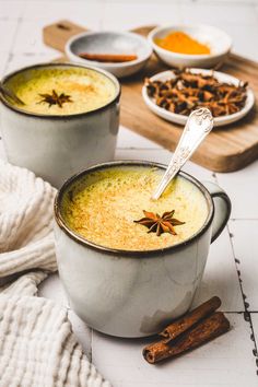 two white bowls filled with soup and spices