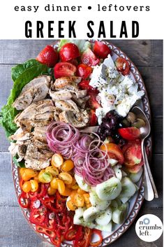 a plate with meat, tomatoes, onions and other vegetables on it next to a fork