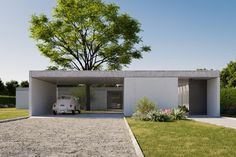 a car is parked in front of a white brick building with an open garage door