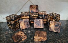 a group of coasters sitting on top of a table covered in brown and black designs