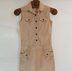 "Denim Button up Sarafan in beige colour. Vintage denim shirt dress. Jeans mini dress button up. Sleeveless sarafan dress perfect for summer time. Mini skirts, mini dress, jeans, denim. Has two side pockets. COLOR: beige FABRIC: 100% cotton Measurements (laying flat) CHEST: 14\" / 36 cm WAIST: 14\" / 35 cm HIPS: 17\" / 44 cm UPPER PART LENGTH: 17\"/ 43 cm SKIRT LENGTH: 14.5\" / 37 cm TOTAL LENGHT: 31.5\" / 80 cm CONDITION: Excellent vintage Please check measurements to insure a proper fit. Remem Beige Mini Dress With Pockets, Fitted Beige Mini Dress With Pockets, Beige Fitted Mini Dress With Pockets, Beige Cotton Dress With Buttons, Casual Beige Mini Dress With Pockets, Sleeveless Beige Mini Dress With Buttons, Casual Beige Mini Dress With Buttons, Beige Button-up Mini Dress, Vintage Cotton Mini Dress With Buttons