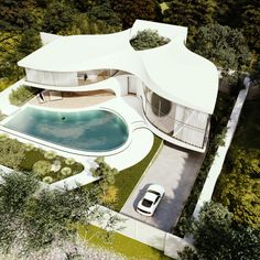 an aerial view of a house with a pool and car parked in the driveway next to it