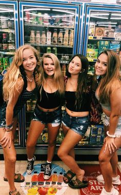 four girls standing in front of a vending machine