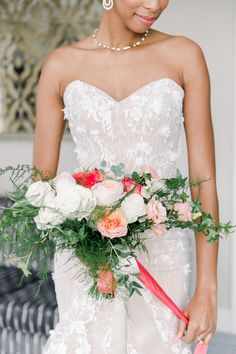 a woman in a wedding dress holding a bouquet