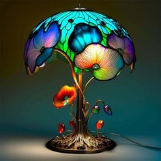 a lamp that is sitting on top of a stand with flowers and leaves around it