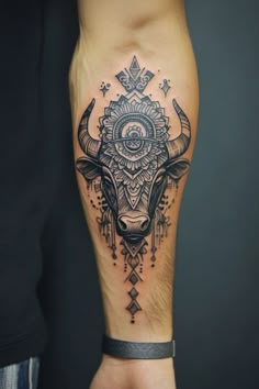 Forearm tattoo of an intricately detailed bull's head with mandala patterns. Carabao Tattoo, Bull Skull Tattoo, Dragon Tattoo Arm, Traditional Black Tattoo, Taurus Art