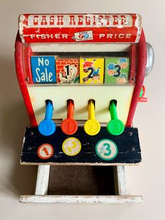 an old toy cash register with numbers on it