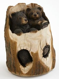 there are two bears that are sitting in the tree stumps on this figurine