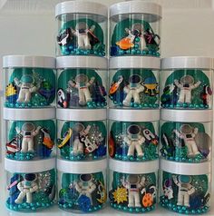 a stack of plastic containers filled with space toys